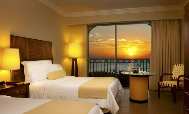 A deluxe ocean view room at sunset — spacious, comfortable, and designed for the ultimate Caribbean escape.